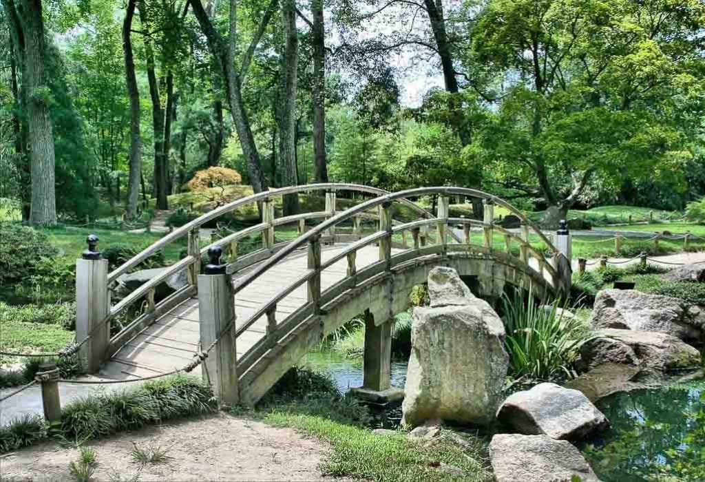 Japanese wooden bridge crosses small river