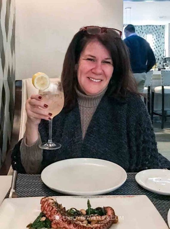 Travel Blogger Jackie Gately (Enjoy Travel Life) enjoys a beverage and octopus dinner at il Molo in Boston's North End.