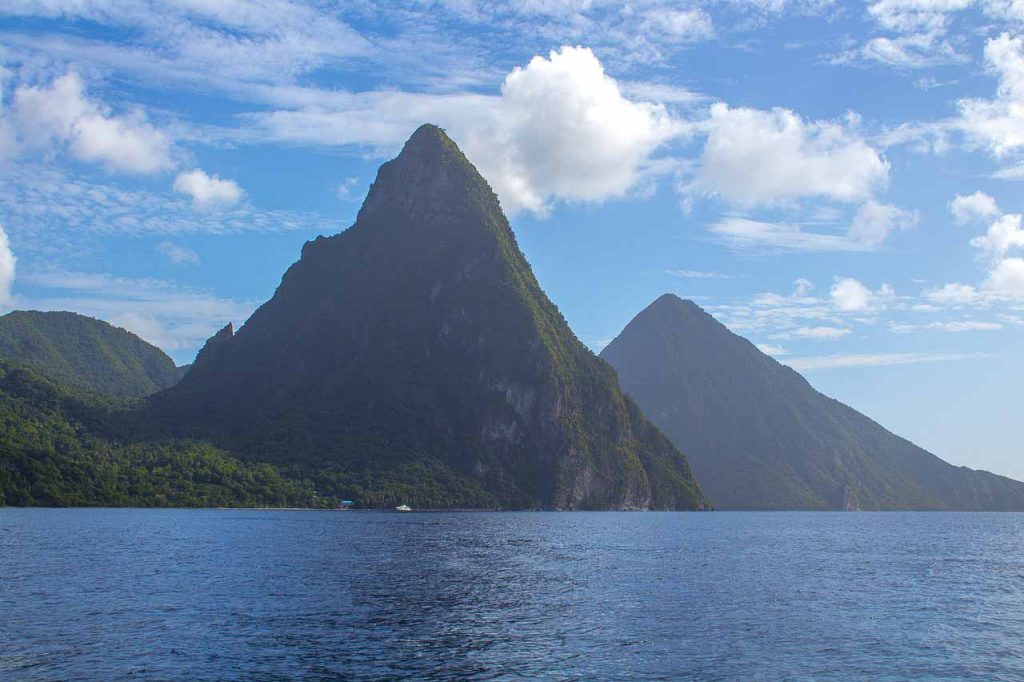 Soaring twin mountains arise from the water in St. Lucia, Caribbean vacation for warm winter getaway