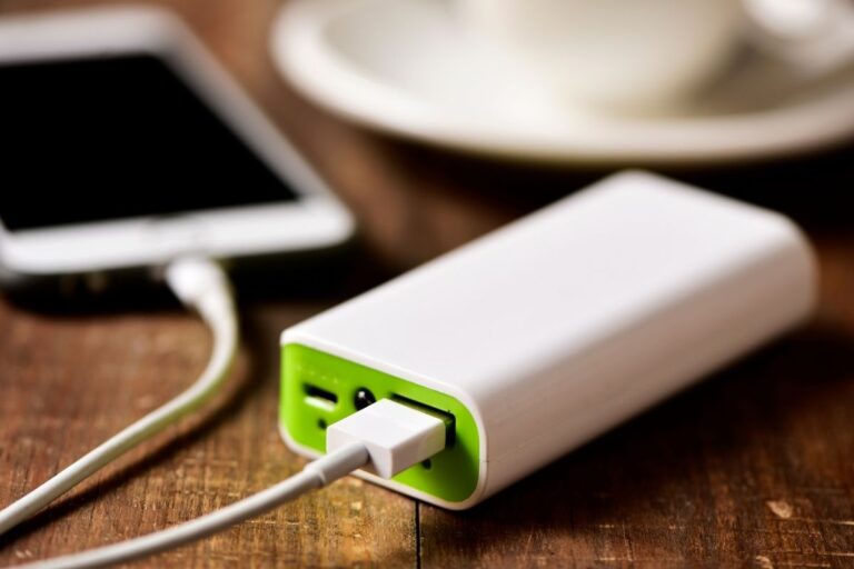 A power bank charges a phone during a travel day.