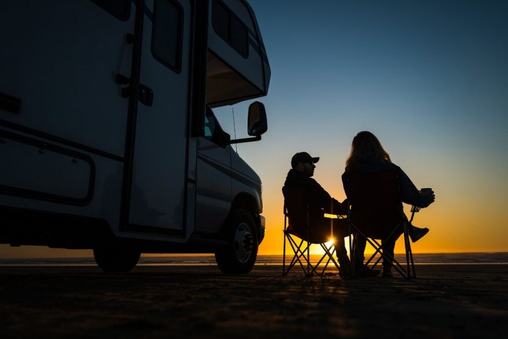couple enjoys RV park at sunset