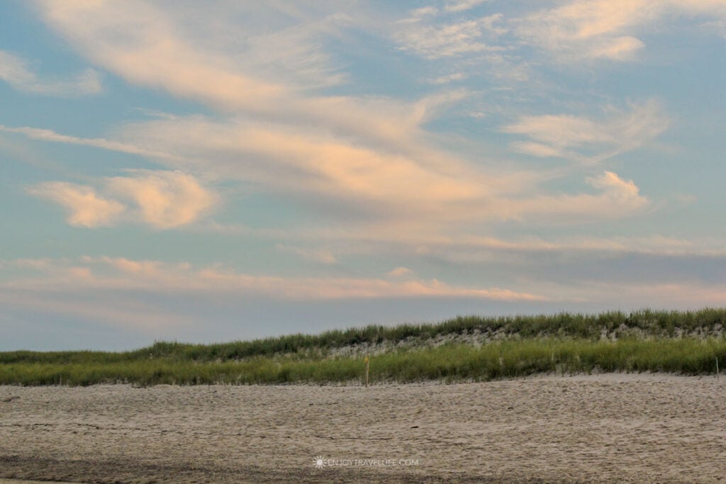 Dune grass and sand at a Brewster beach on Cape Cod Bay at dusk.