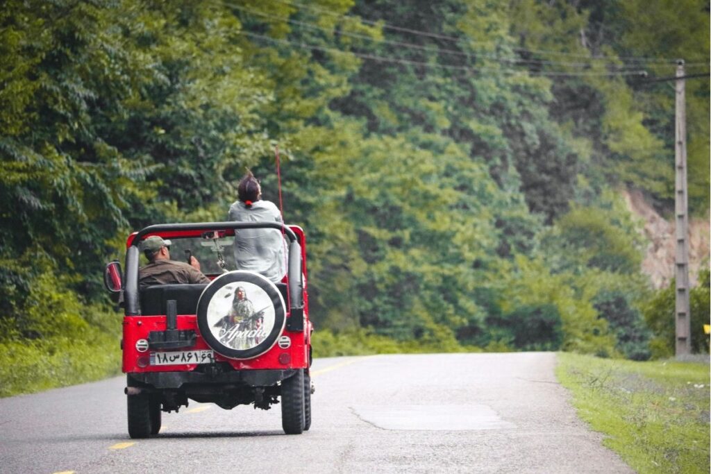 getting around Martha's Vineyard: Open-top jeep driving down a tree-lined road