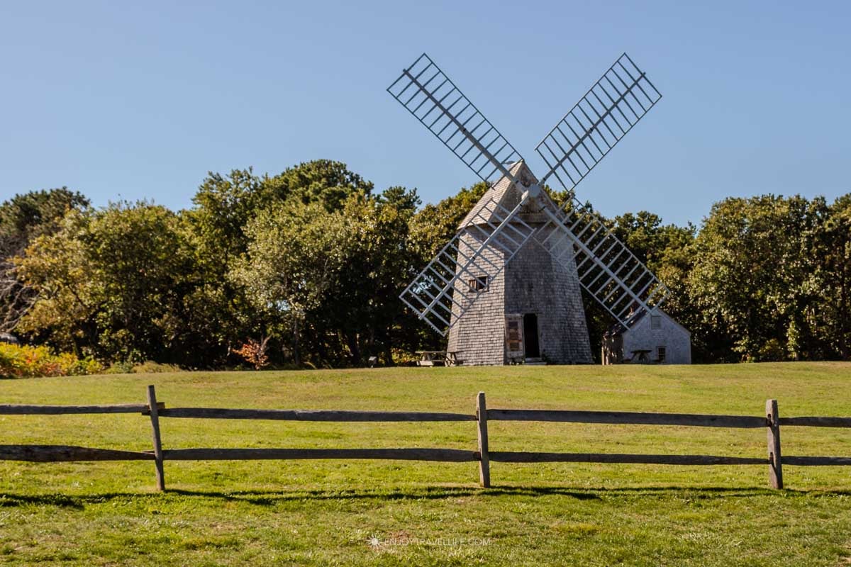 Things to do in Brewster MA: Higgins Farm Windmill on the green at the Brewster Historical Society in Cape Cod.