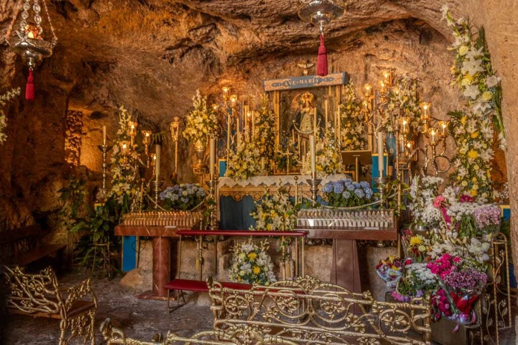 Inside the Ermita de la Virgen de la Pena cave chapel in Mijas Spain with golden altar