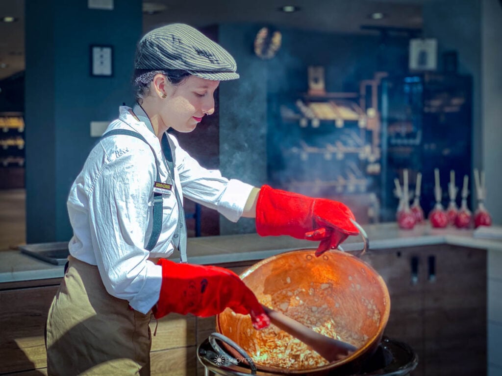 A local cook prepares paella in an open window in the village of Mijas, Spain.
