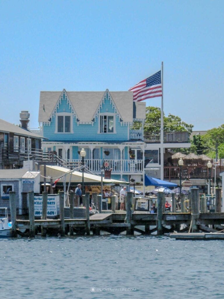 Colorful Victorian waterfront building with an American flag on the Oak Bluffs harbor dock on Martha's Vineyard