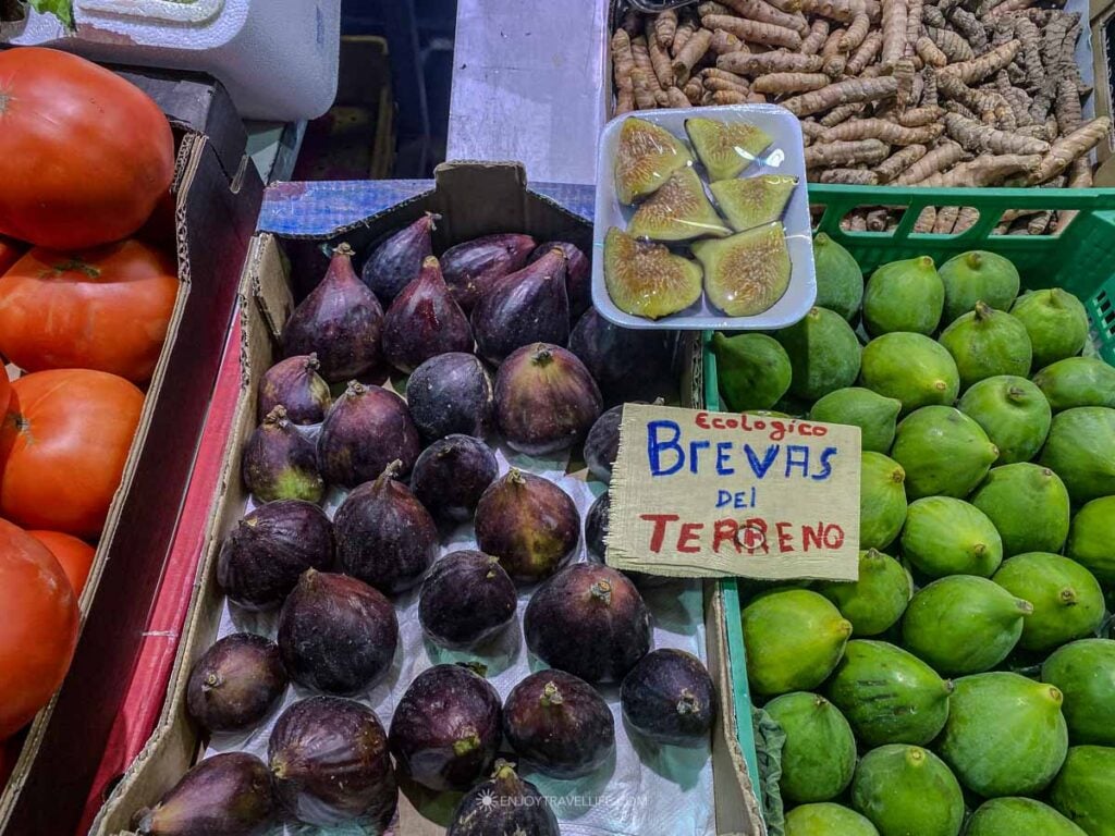 A produce stall piled with fresh figs at the Mercado de Triana in Seville.