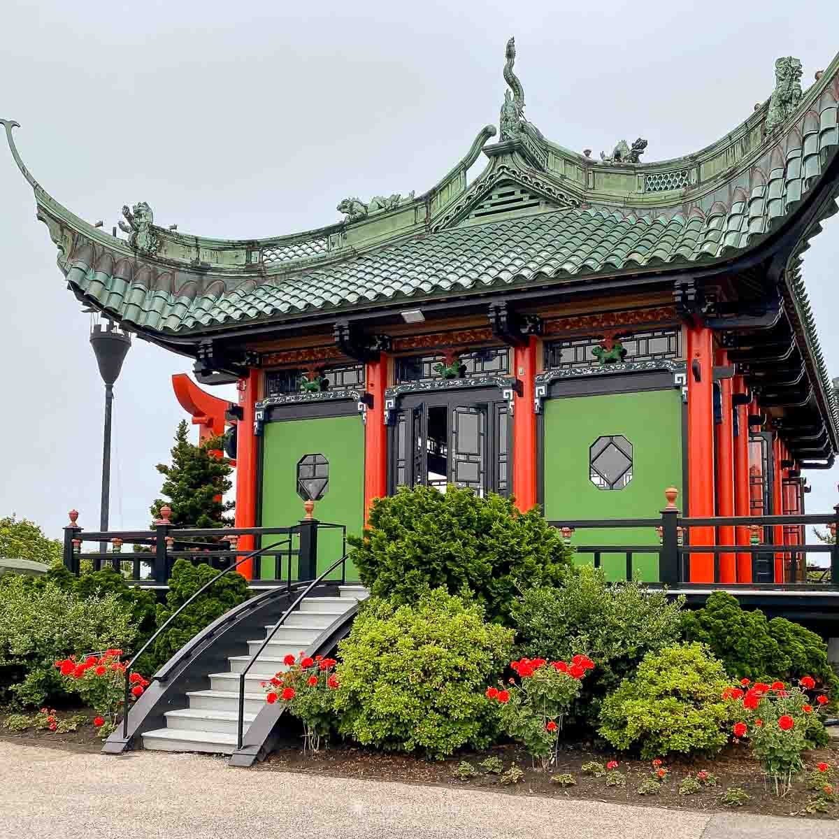 The red-and-green Chinese Tea House perches above the water behind Marble House in Newport.