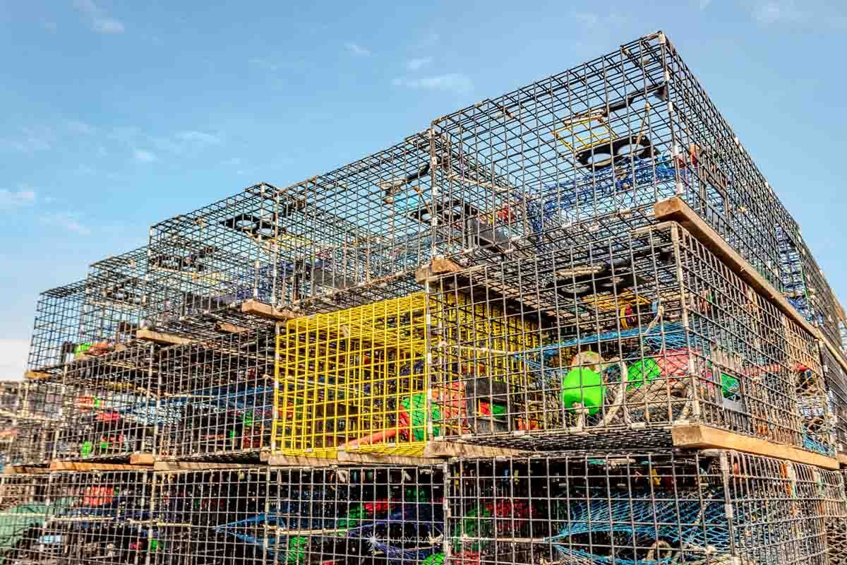 Lobster traps are stacked in tall walls along the working dock on Monhegan Island.