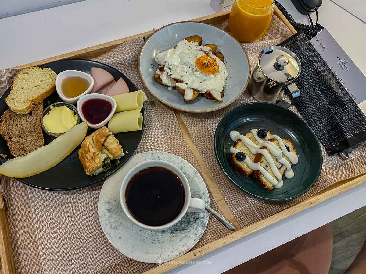 A breakfast tray with eggs, bread, pastries, and Greek coffee at The Marblous hotel in Athens, Greece.