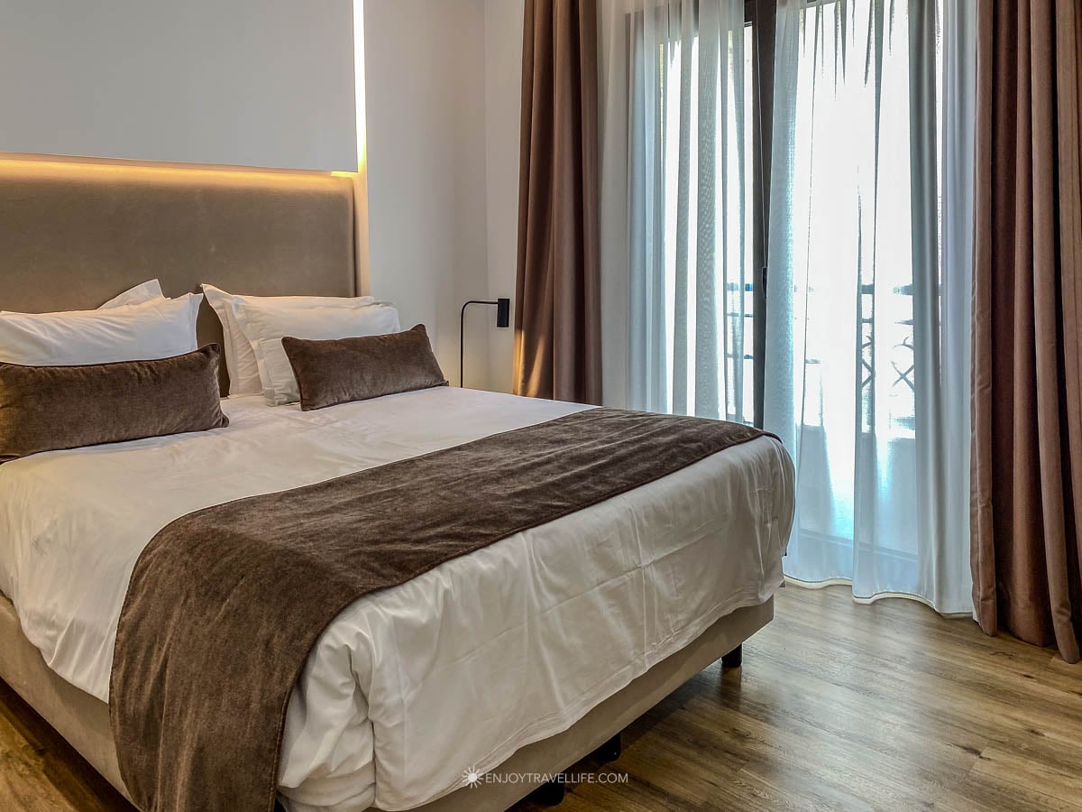 A clean, modern guest room with a large bed at The Marblous hotel in central Athens, Greece.