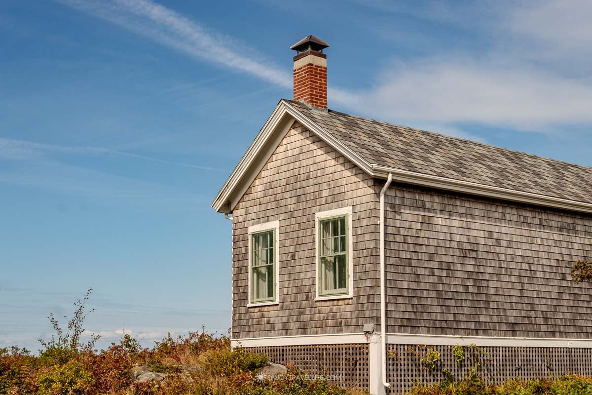 A small weathered-shingle cottage with a brick chimney on Monhegan Island.