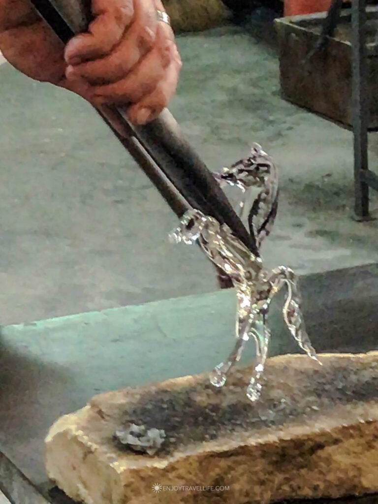 A delicate handblown glass figurine shows the fine detail of Murano craftsmanship up close.