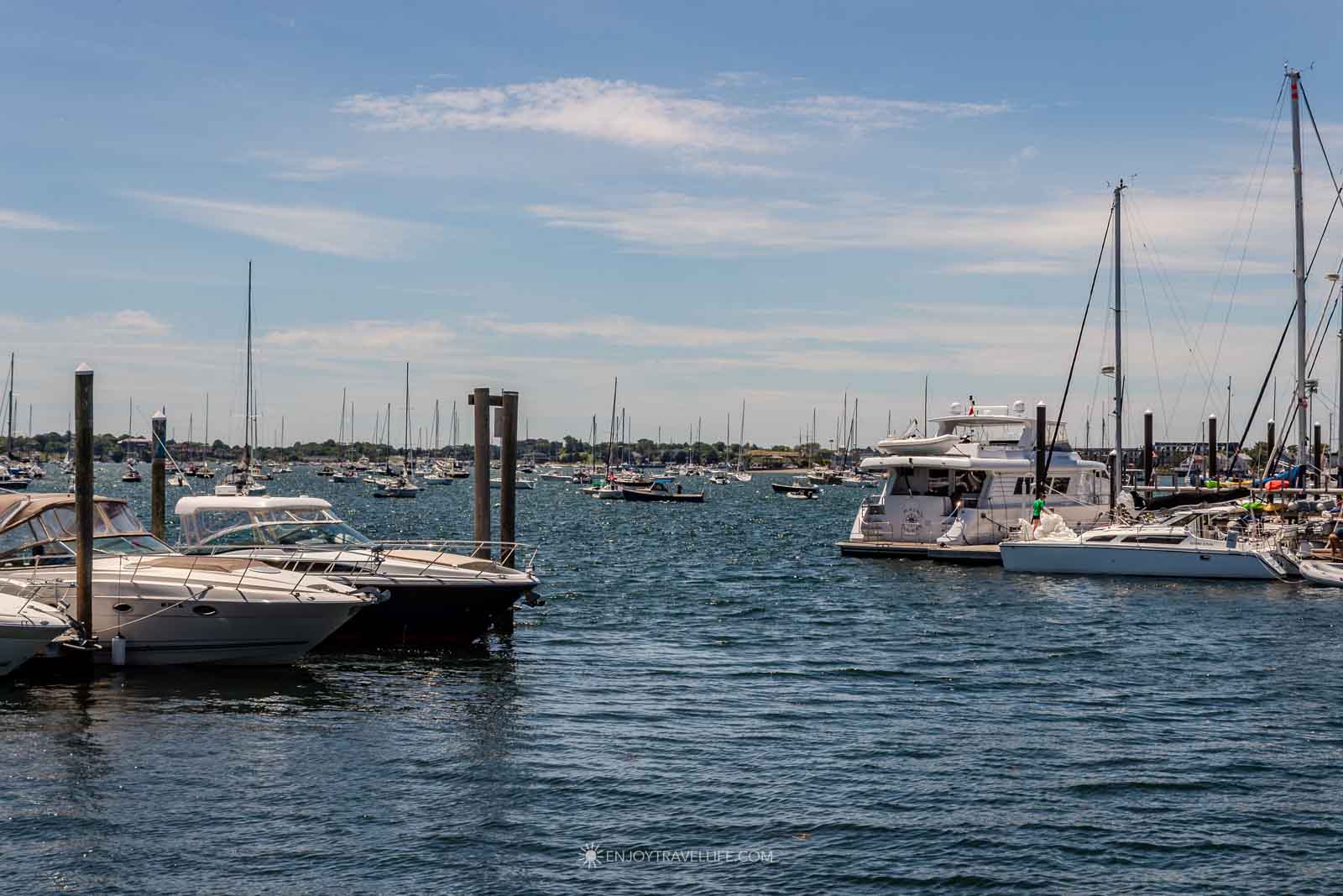Sailboats fill the harbor on a sunny Newport Rhode Island summer afternoon.