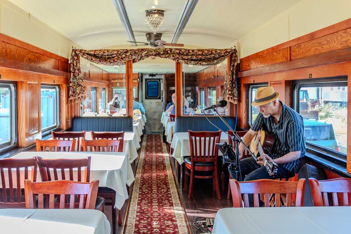 A restored vintage dining car is set for dinner aboard the Newport sunset train.