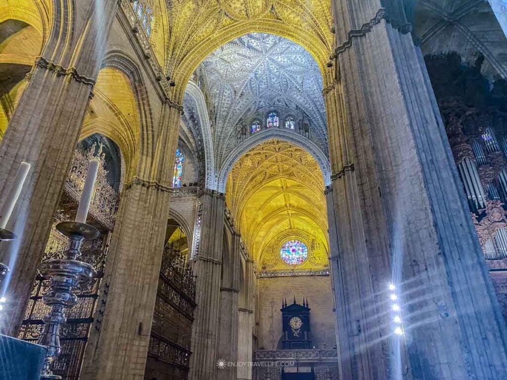 The vaulted Gothic ceiling and stained glass of Seville Cathedral, the largest Gothic cathedral in the world.
