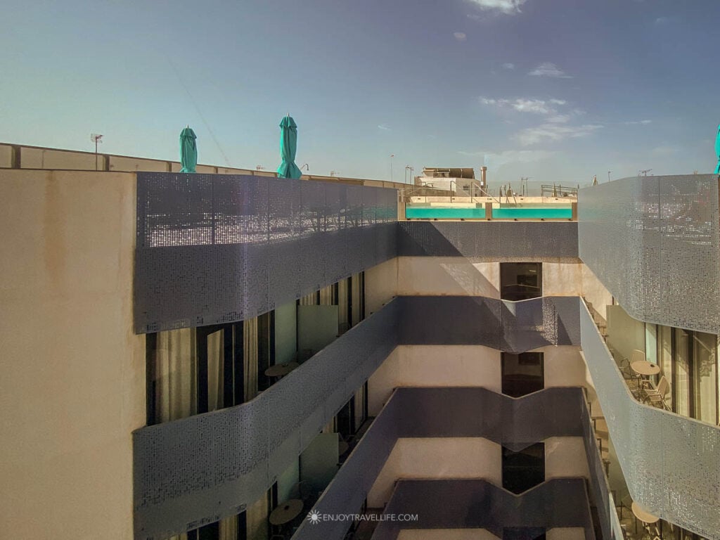 The stepped balconies and rooftop infinity pool of the Hotel Macià Sevilla Kubb in Seville.