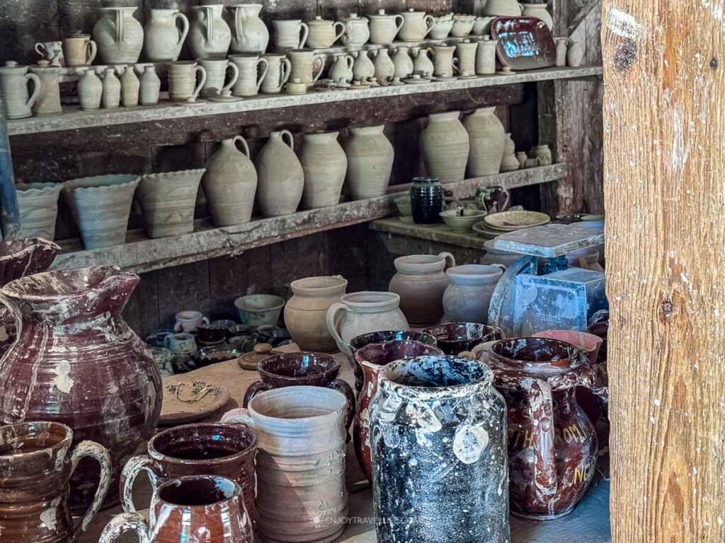Finished redware and stoneware crowd the shelves of the pottery shop.