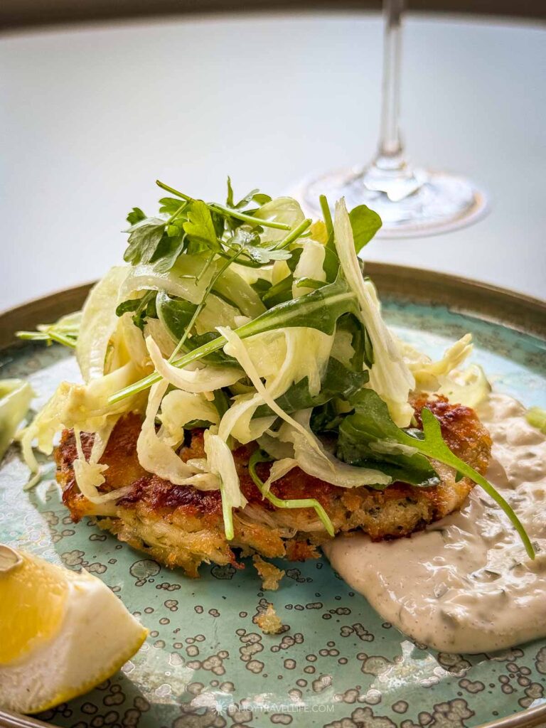 A crab cake with shaved fennel on the terrace at Rowes Wharf Sea Grille in Boston before an evening sail.