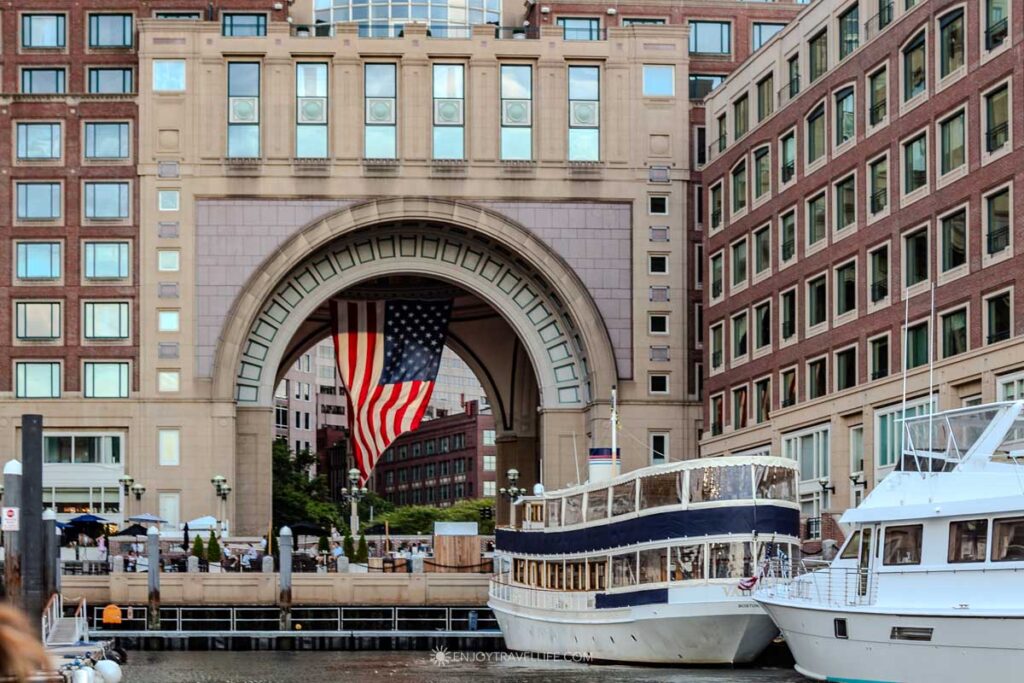 The Rowes Wharf archway and its American flag seen from the water as the schooner leaves the dock in Boston.