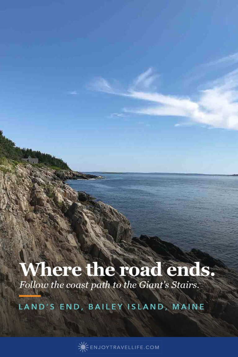 The rocky shoreline at Land's End on Bailey Island, Maine, under a blue sky.