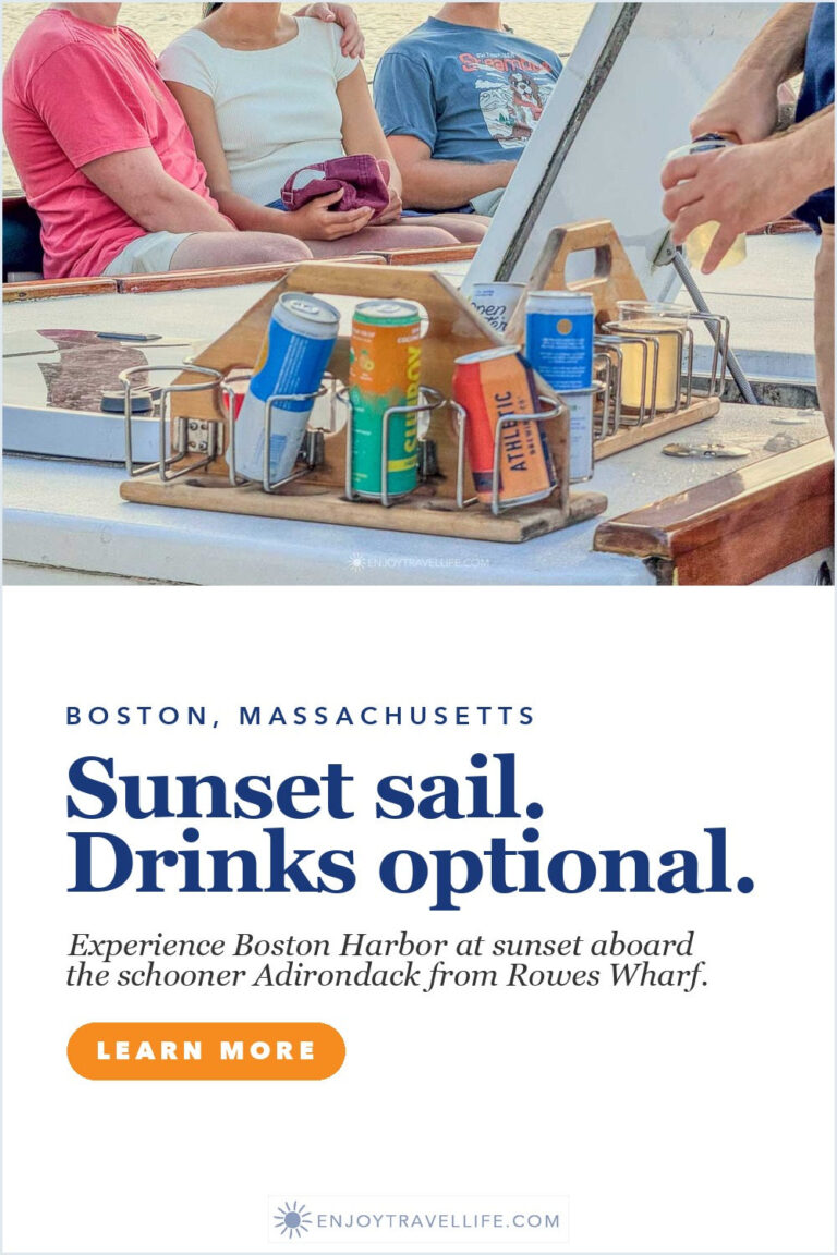Passengers with canned drinks on the deck of a schooner during a sunset sail on Boston Harbor.
