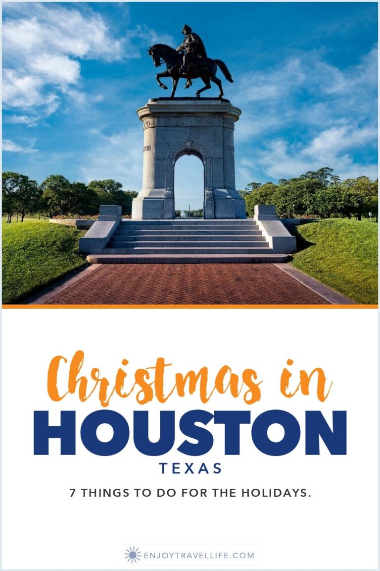 The Sam Houston equestrian statue on its stone arch in Hermann Park, Houston, Texas, under a blue sky.