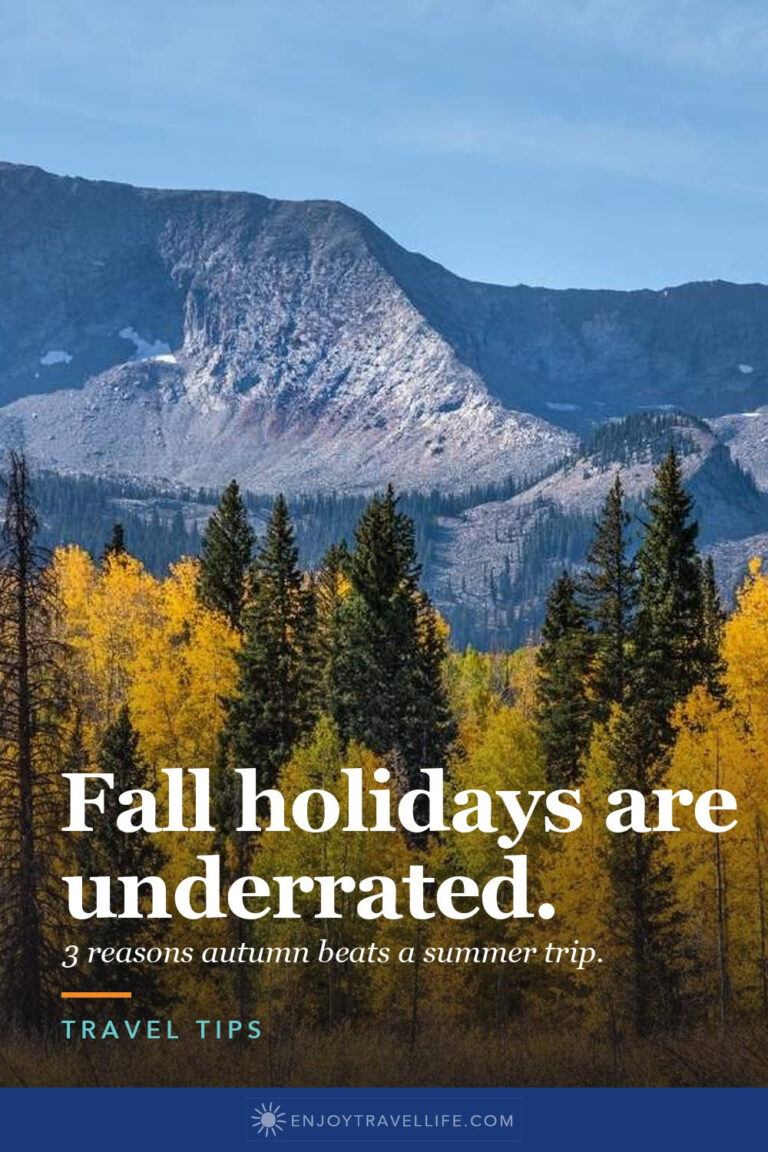 Snow-capped mountains above golden aspens.