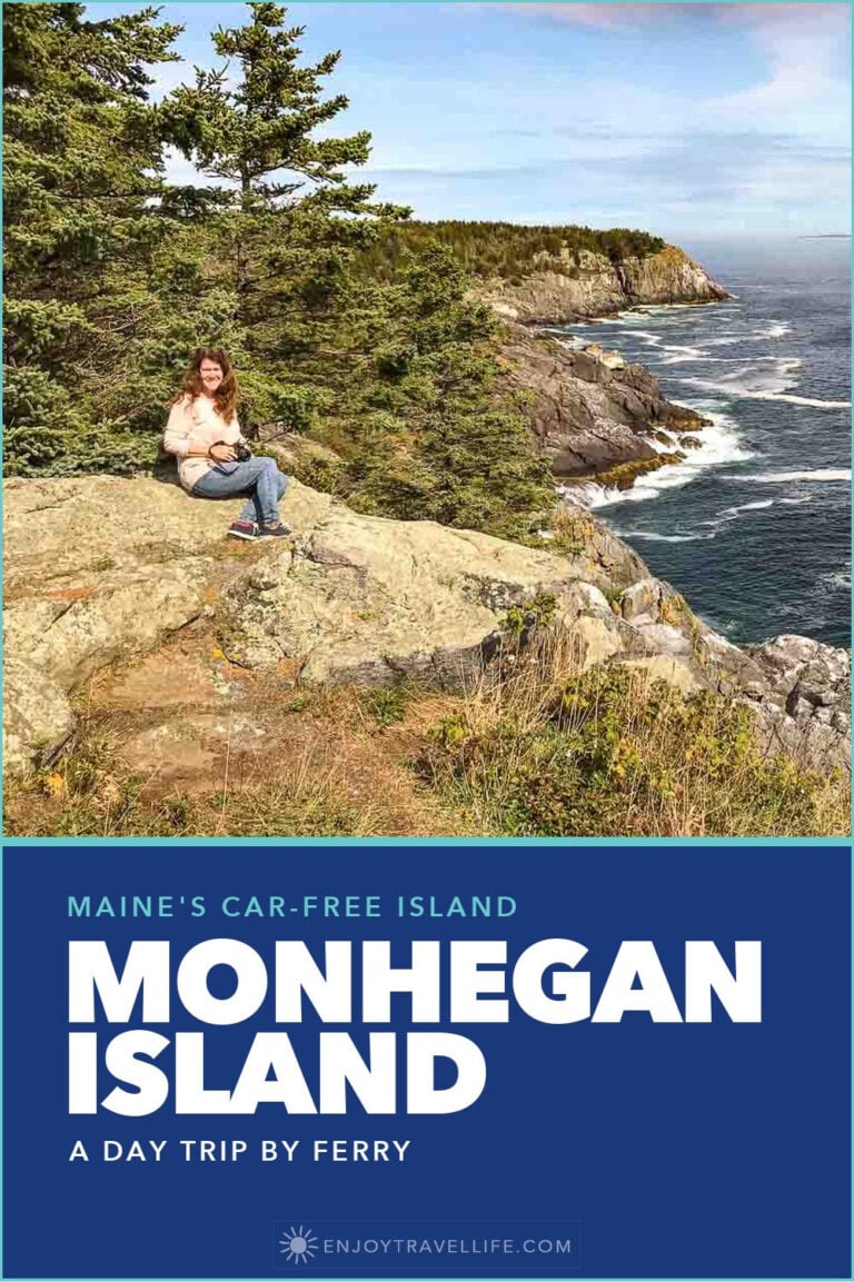 A woman sits on the rocks above the surf on Monhegan Island, Maine, with the cliffs behind her.