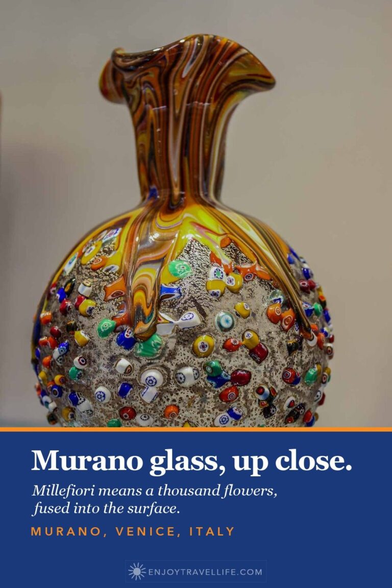 A golden Murano glass vase covered in colorful millefiori dots in a showroom on Murano, Italy.