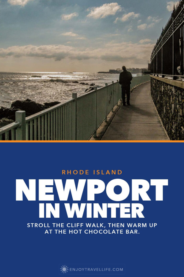 A man walks the Newport Cliff Walk beside the ocean in Rhode Island.
