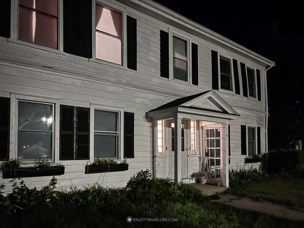A white clapboard house on King Street in Plymouth, Massachusetts, seen at night.