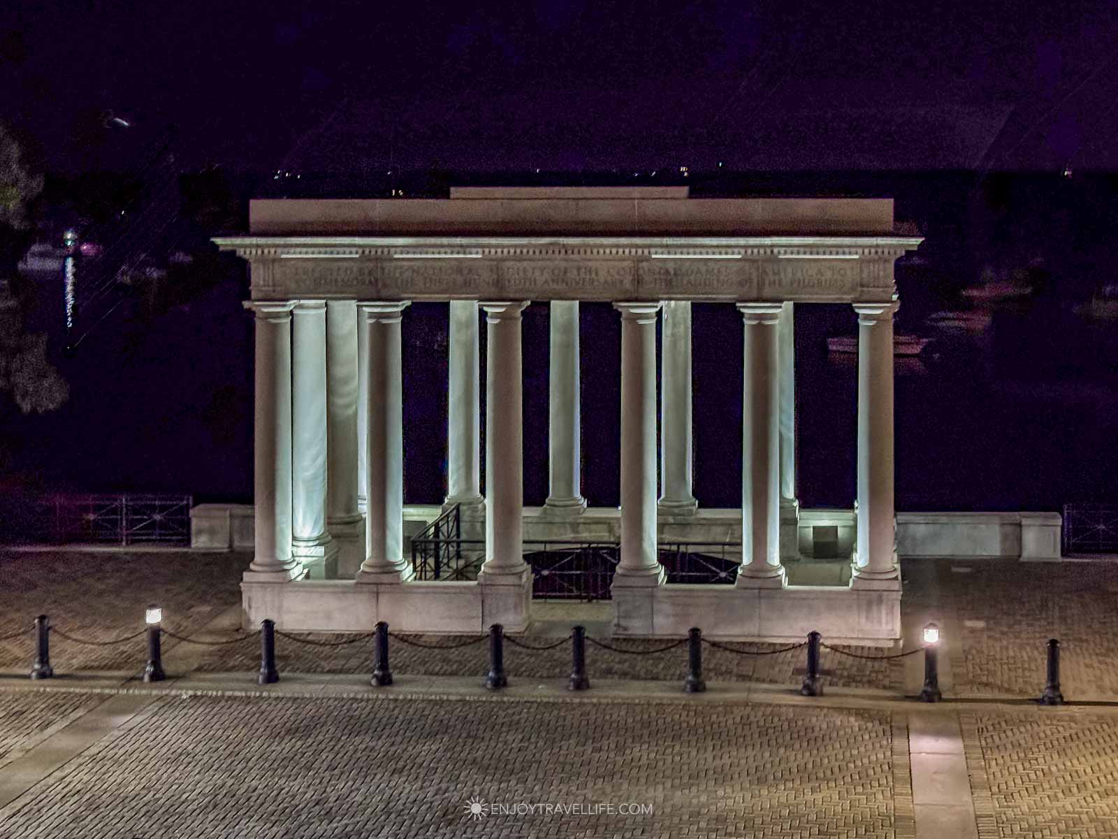 The Plymouth Rock portico lit at night, where the tour meets.