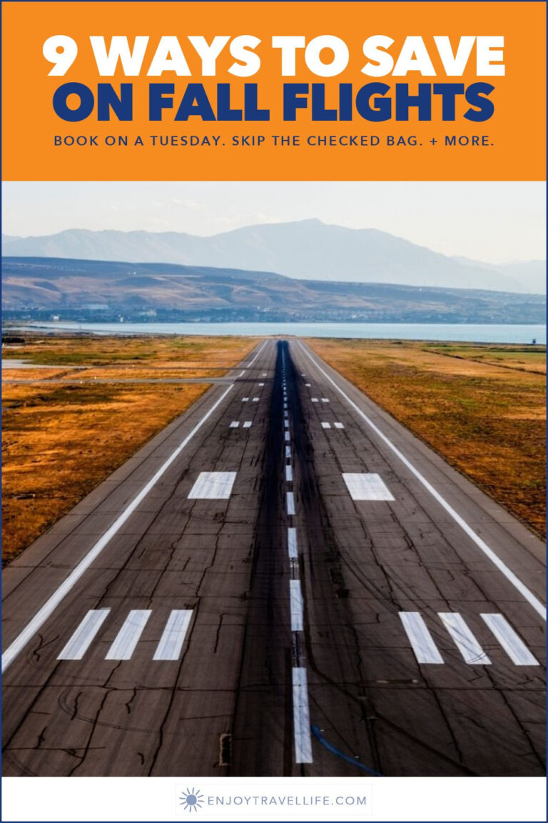 An airport runway stretching toward autumn hills.