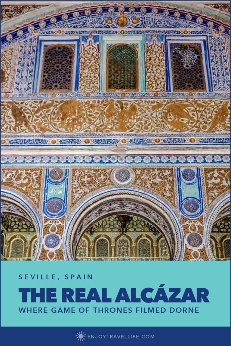 Ornate Mudéjar tilework and arches inside the Real Alcázar in Seville, Spain.