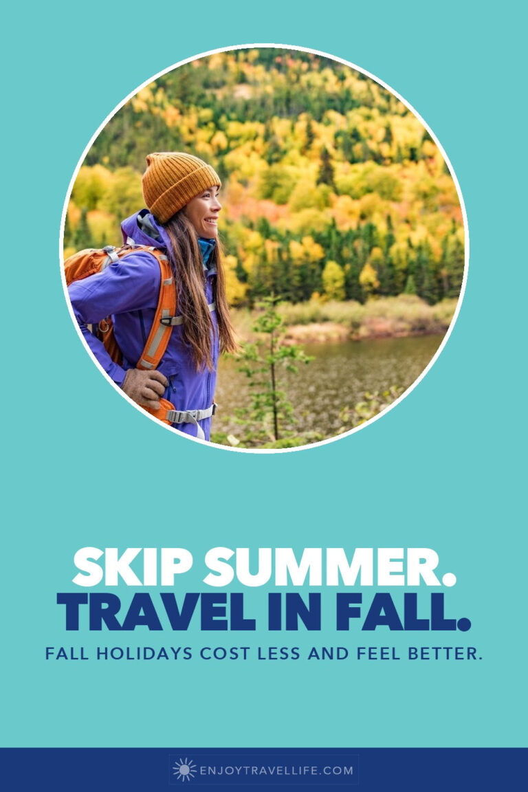 A hiker in a yellow hat overlooks fall foliage.