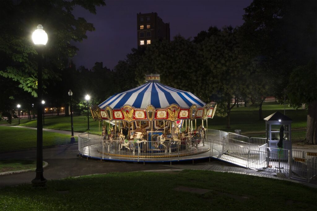 The Boston Common carousel glows under lamplight at night, a first stop on a New England fall road trip.