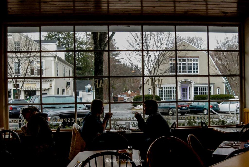 Two diners sit by the front windows of the Main Street Cafe in Stockbridge, across from the Red Lion Inn.