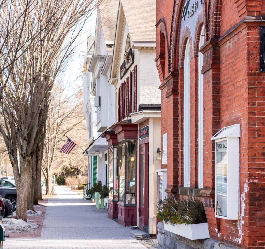 Brick and clapboard shopfronts line Main Street in Stockbridge, Massachusetts.