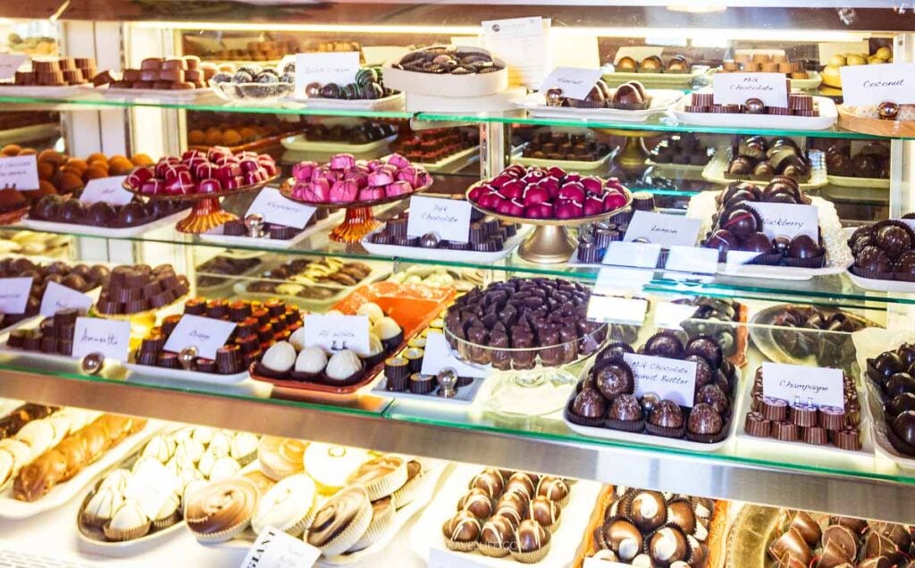 Trays of truffles and chocolates in the glass case at Peace Love and Chocolate in Stockbridge.