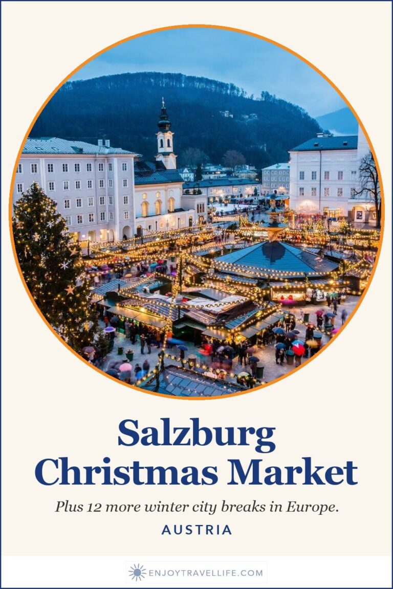The Christmas market in Salzburg, Austria with the old town and fortress behind it.